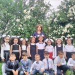Children with their teacher in a garden