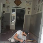 Man removing floor with a powertool.
