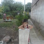 A child drinking from a water fountain
